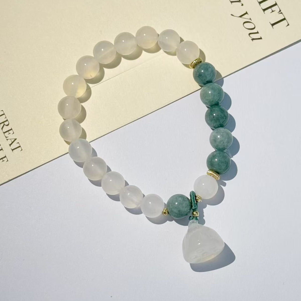 The lotus begets all creation �?White jade bracelet