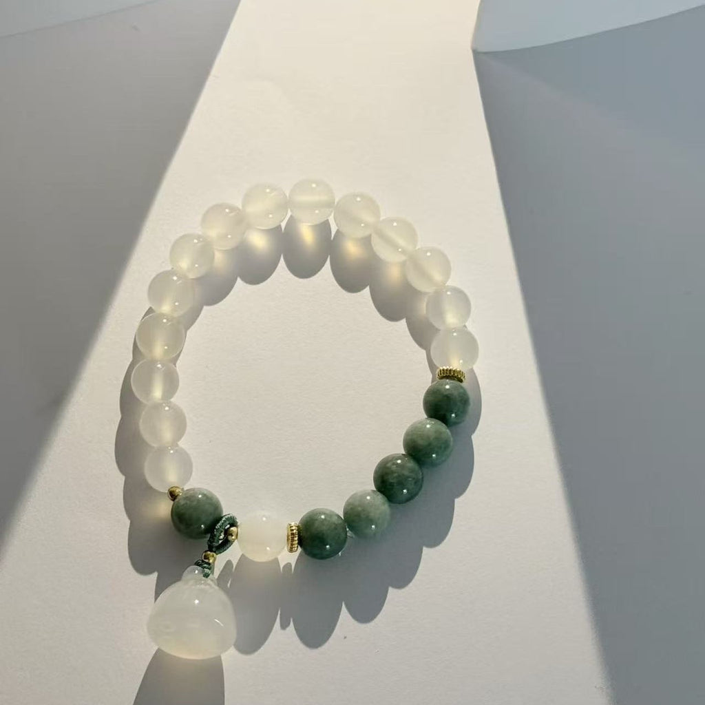 The lotus begets all creation �?White jade bracelet
