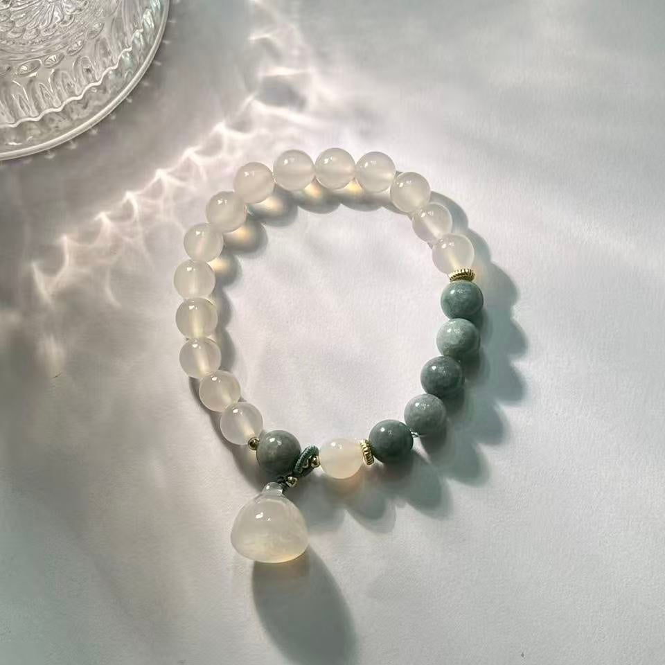 The lotus begets all creation �?White jade bracelet