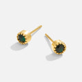 Victoria – Gold earrings adorned with green stones.