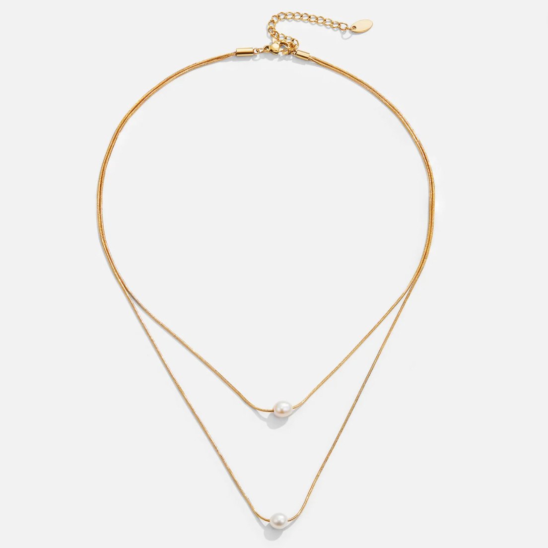 Sabine – Two-layer gold chain with a dark stone.