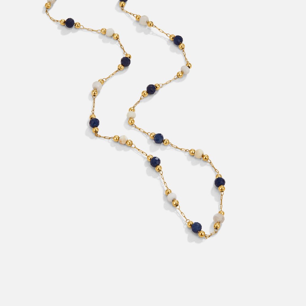 Teresa – A delicate necklace with intricate black and white details.