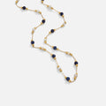 Teresa – A delicate necklace with intricate black and white details.