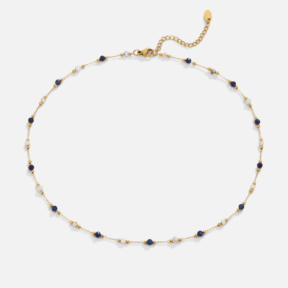 Teresa – A delicate necklace with intricate black and white details.