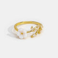Miriam – An engagement ring adorned with white floral decorations.